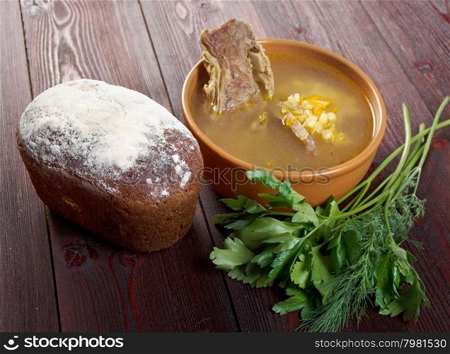 Pea soup with beef ribs and farmhouse bread,edible greens .farmhouse kitchen