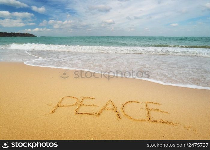 Peace word on sea sandy shore. Nature conceptaul composition.