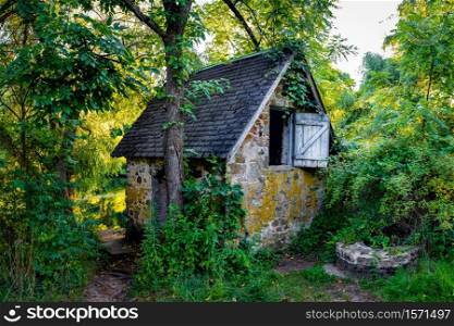 Peaceful abandoned old cottage at summer sunset in the woods nobody. Peaceful abandoned old cottage at summer sunset in the woods