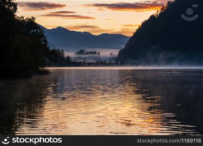 Peaceful autumn Alps mountain lake. Sunrise Wolfgangsee lake view, St. Wolfgang im Salzkammergut, Upper Austria.