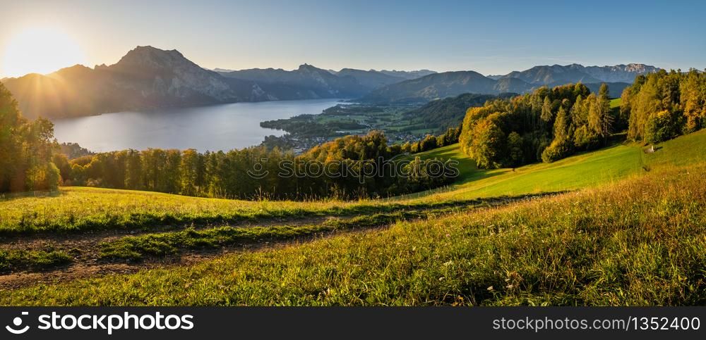 Peaceful autumn Alps mountain lake with clear transparent water and reflections. Sunrise view to Traunsee lake, Gmundnerberg, Altmunster am Traunsee, Upper Austria.