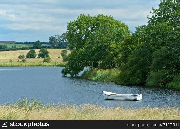 Peaceful Countryside. Beautiful Scenic Countryside With a Boat on a Lake in Scotland