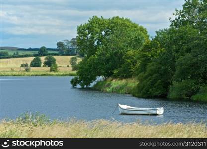 Peaceful Countryside. Beautiful Scenic Countryside With a Boat on a Lake in Scotland