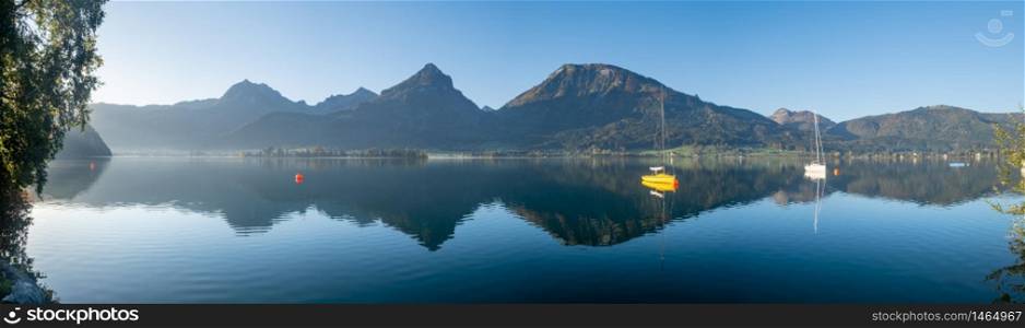 Peaceful mountain lake with clear transparent water and reflections. Autumn Wolfgangsee lake panorama, St. Wolfgang im Salzkammergut, Upper Austria.