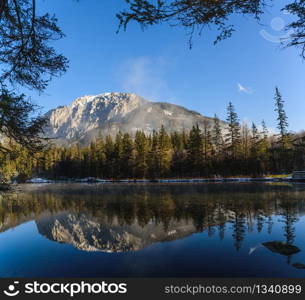 Peaceful mountain view with Kreuzteich in Austria Styria. Tourist destination lake Gruner See in winter. Travel spot situated in Tragos in lime stone Alps of Hochschwab.. Peaceful mountain panorama view with Kreuzteich in Austria Styria. Tourist destination lake Gruner See in winter.