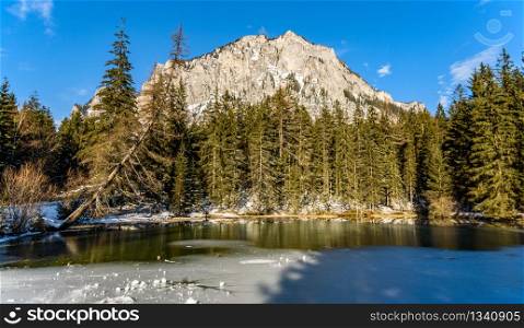 Peaceful mountain view with Pfarrerteich lake in Austria Styria. Tourist destination lake Gruner See in winter. Travel spot situated in Tragos in lime stone Alps of Hochschwab.. Peaceful mountain panorama view Pfarrerteich lake in Austria Styria. Tourist destination lake Gruner See in winter.