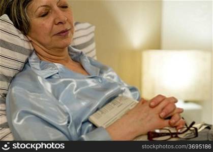Peaceful portrait of sleeping old woman in bed