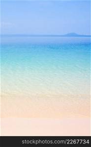 Peaceful summer, turquoise blue seawater and light blue sky, beautiful sand beach and gently waves, island background. Sunshine day. Vacation time concept. Copy space. Thailand.