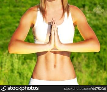Peaceful yoga outdoor, healthy sporty female body over green natural background, body care &amp; fitness concept
