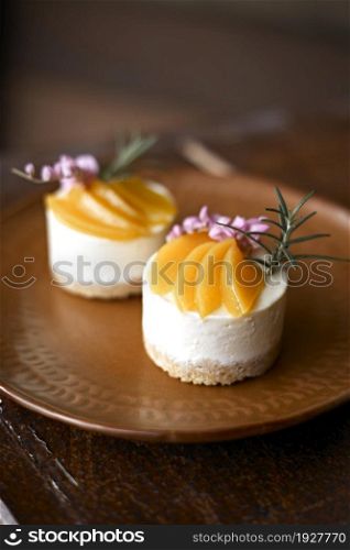Peach cheesecake on wooden table. Peach cheesecake