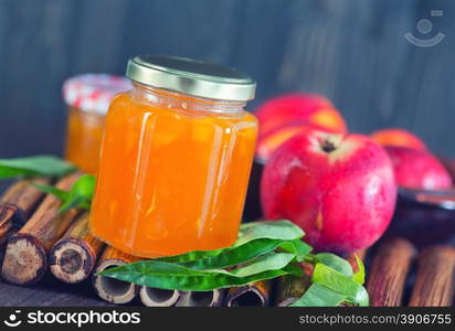 peach jam in glass bank and on a table