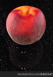 Peach on a dark background with droplets