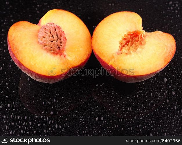 Peach on a dark background with droplets