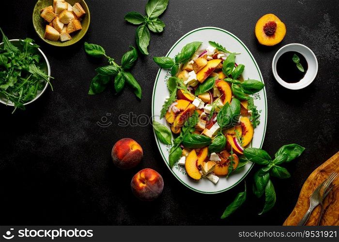 Peach Panzanella salad with crusty bread, basil leaves, arugula, feta cheese and balsamic vinegar, top view