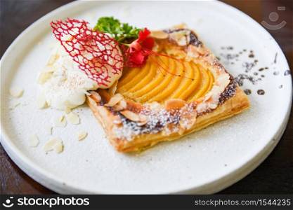 Peach Pie on white plate / Homemade dessert delicious cake with peaches and icing sugar