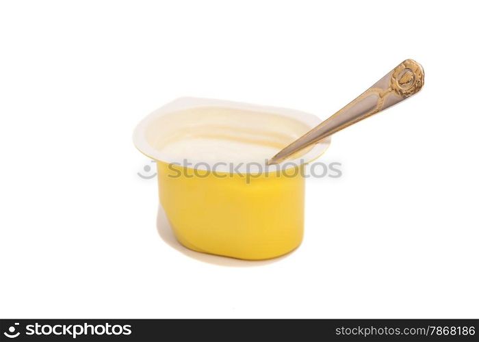 Peach yoghurt in open plastic cup with spoon isolated on white