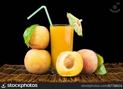 Peaches and glass with juice black isolated studio shot.