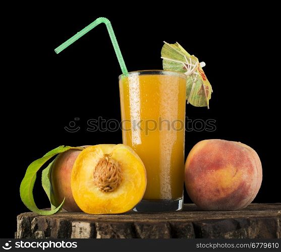 Peaches and glass with juice black isolated studio shot.