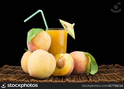 Peaches and glass with juice black isolated studio shot.