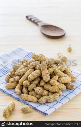 Peanut arranged on a wooden floor.