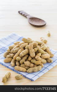 Peanut arranged on a wooden floor.