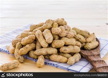 Peanut arranged on a wooden floor.