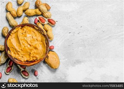 Peanut butter in the bowl . On a rustic background.. Peanut butter in the bowl .