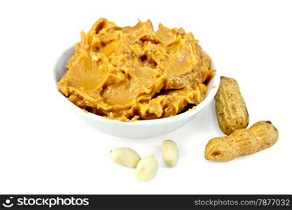 Peanut butter in the bowl, peanuts in the shell and cleaned isolated on white background