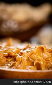 Peanut butter on a plate. Macro background. High quality photo. Peanut butter on a plate. Macro background.