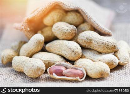 Peanut in shells for food or snack / Roasted peanuts on sack background