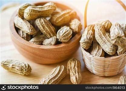 Peanut in wooden cup bowl and wood background top view / Boiled peanuts