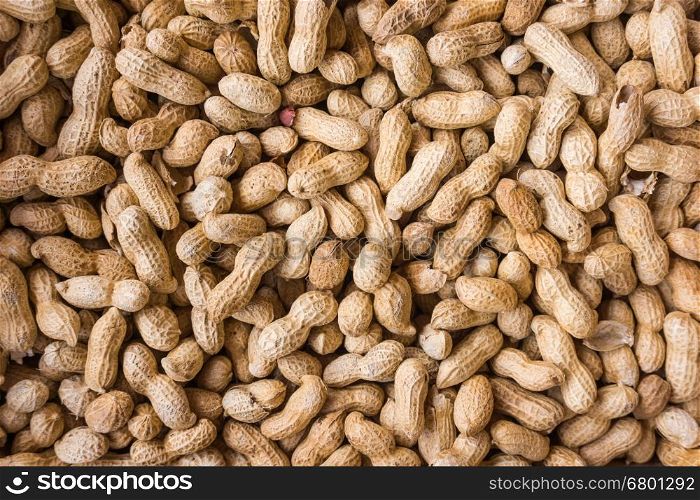 Peanuts background. Raw peanuts. Many peanuts in shells