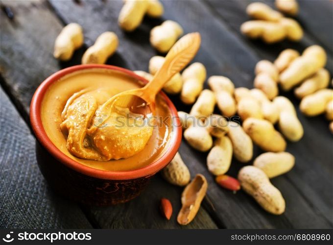 peanuts butter in bowl and on a table