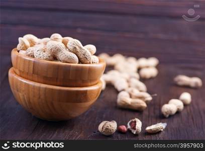 peanuts in bowl and on a table