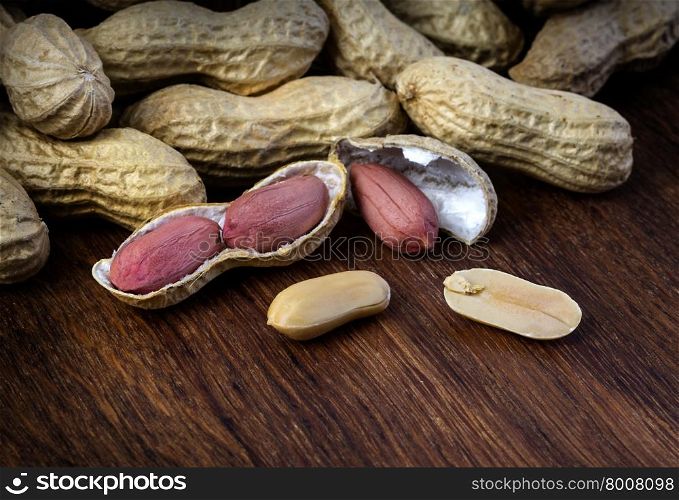 Peanuts in shells on vintage wooden background