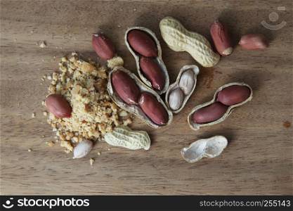 Peanuts in shells on wood background