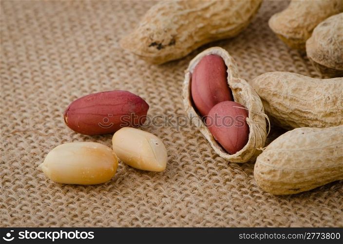 Peanuts on old raffia background.