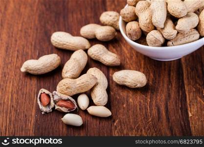 peanuts. Peanuts isolated on a wooden table