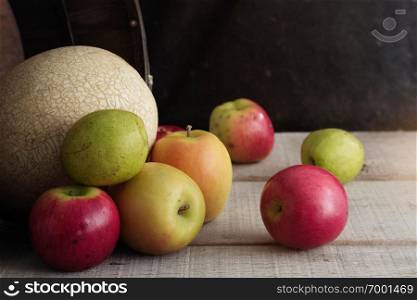 Pear and other fruits on wooden floor.