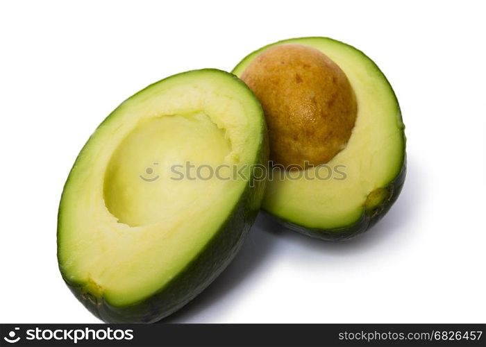 Pear-shaped avocado half and whole isolated on white background