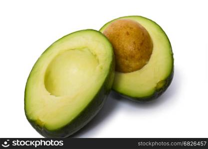 Pear-shaped avocado half and whole isolated on white background