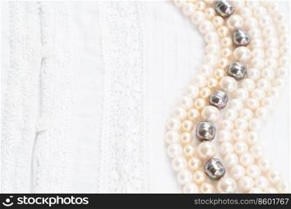 Pearl jewellery styled stock scene, for wedding invitation, product showcase or styled presentation with copy space, top view. Gray silk styled stock scene