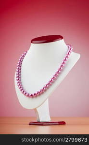 Pearl necklace against gradient background