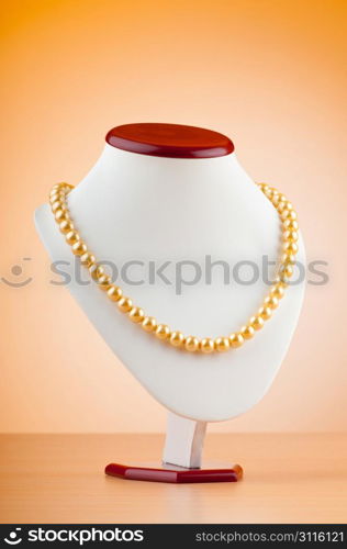 Pearl necklace against gradient background