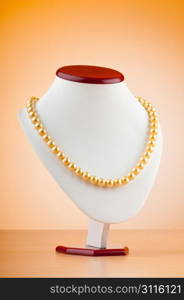 Pearl necklace against gradient background