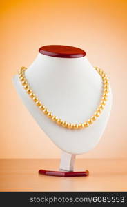 Pearl necklace against gradient background