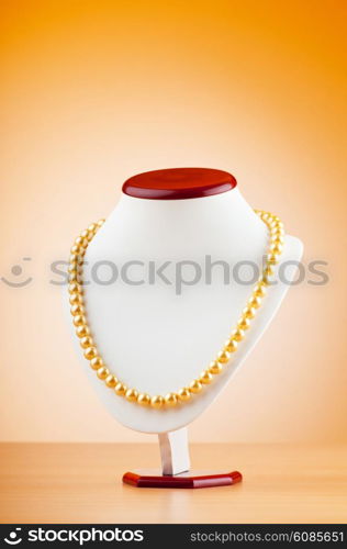 Pearl necklace against gradient background