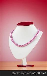 Pearl necklace against gradient background