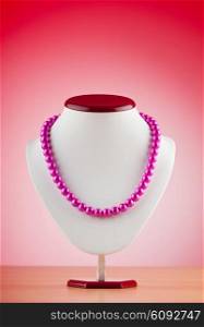 Pearl necklace against gradient background