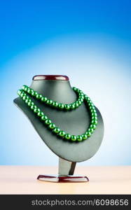 Pearl necklace against gradient background